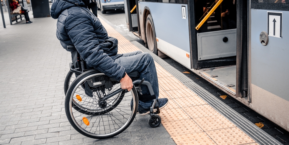 Man in wheelchair boards low-floor bus