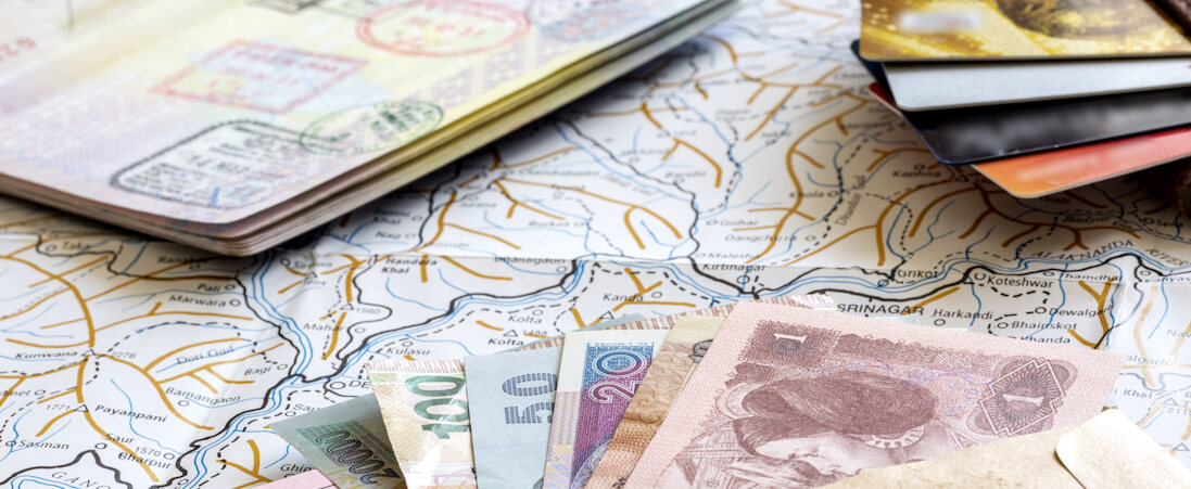 a map, passport, different currencies and bank cards