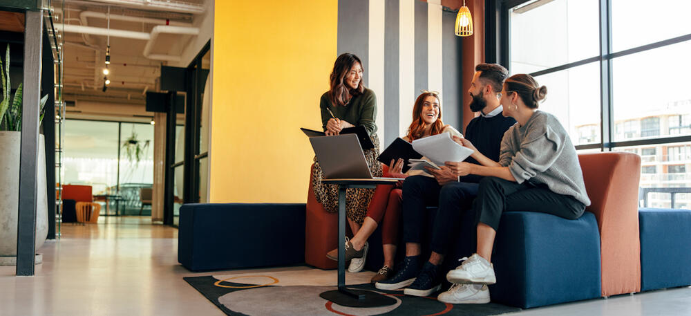 Co-workers gathering in the workspace
